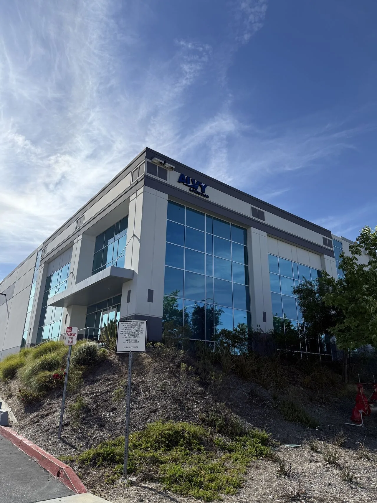The Alvy Logistics warehouse in Valencia, California, with the Alvy sign above the glass entrance